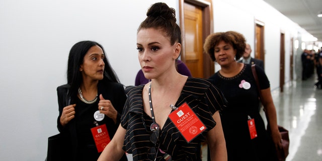 Actress Alyssa Milano walks to a Senate Judiciary Committee meeting after a break on Capitol Hill in Washington, Thursday, Sept. 27, 2018, during a hearing for Supreme Court nominee Brett Kavanaugh.