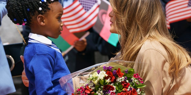 First lady Melania Trump is greeted by a flower girl as she arrives at Lilongwe International Airport, in Lumbadzi, Malawi. (AP Photo/Carolyn Kaster)