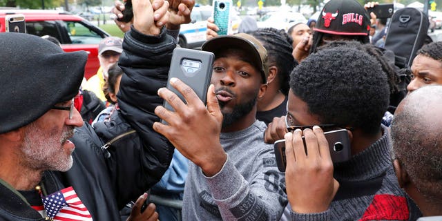 Protesters react in front of George N Leighton Criminal Courthouse Friday, Oct. 5, 2018, in Chicago. A jury on Friday convicted white Chicago police officer Jason Van Dyke of second-degree murder in the 2014 shooting of black teenager Laquan McDonald. (AP Photo/Nam Y. Huh)