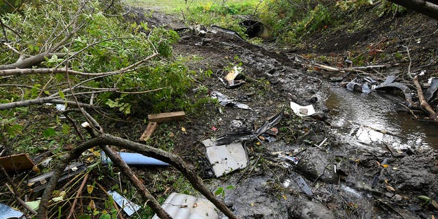 Debris scatters an area at the site of Saturday's fatal crash Schoharie, N.Y.