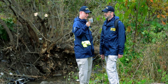 Members of the National Transportation Safety Board work at the scene of yesterday's fatal crash, in Schoharie, N.Y.