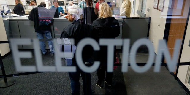 Some states allow residents to register to vote on Election Day. (AP Photo/Charlie Neibergall)