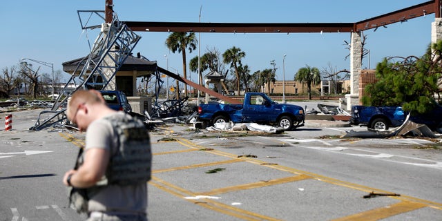 A soldier stands guard at the damaged entrance to Tyndall Air Force Base.