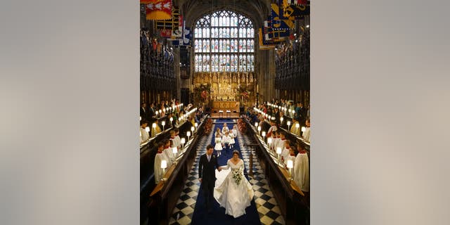 Princess Eugenie of York and Jack Brooksbank after their wedding ceremony at St George’s Chapel, Windsor Castle, near London, England, Friday Oct. 12, 2018. (Jonathan Brady, Pool via AP)