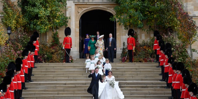 Britain's Princess Eugenie and Jack Brooksbank leave St George's Chapel after their wedding at Windsor Castle, near London, England, Friday Oct. 12, 2018. (Toby Melville, Pool via AP)