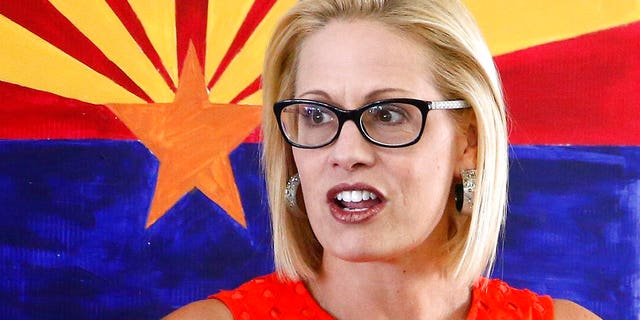 Then-U.S. Rep. Kyrsten Sinema, D-Ariz., talks to campaign volunteers in Phoenix in August 2018 during her U.S. Senate campaign. (Associated Press)