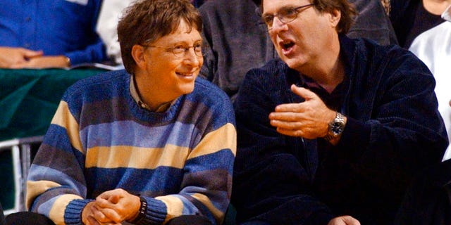In this March 11, 2003 file photo, Microsoft Chairman Bill Gates, left, chats with Portland Trail Blazers owner and former business partner Paul Allen during a game between the Trail Blazers and Seattle SuperSonics in Seattle.