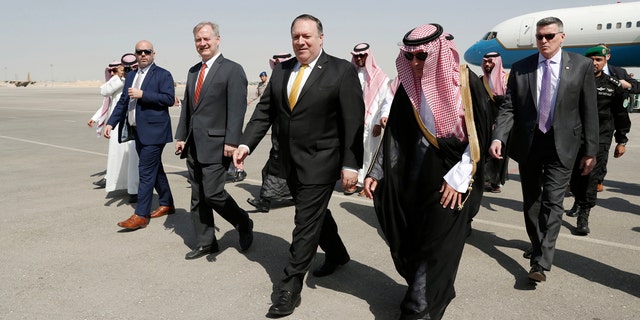 U.S. Secretary of State Mike Pompeo, second right in front, walks with Saudi Foreign Minister Adel al-Jubeir after arriving in Riyadh, Saudi Arabia, Tuesday, Oct. 16, 2018. (Leah Millis/Pool Photo via AP)