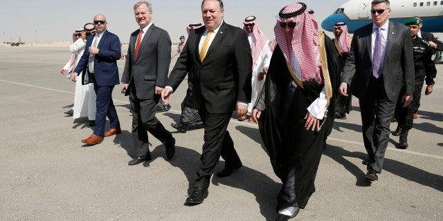 U.S. Secretary of State Mike Pompeo, second right in front, walks with Saudi Foreign Minister Adel al-Jubeir after arriving in Riyadh, Saudi Arabia, Tuesday, Oct. 16, 2018. (Leah Millis/Pool Photo via AP)