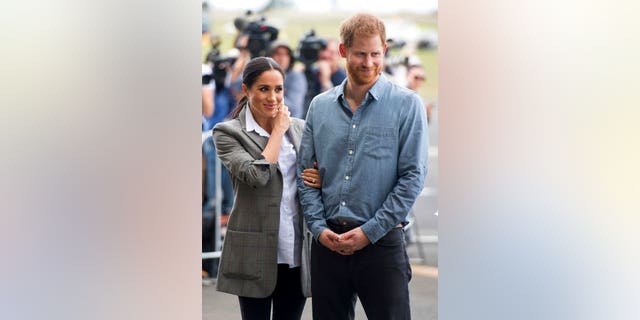 Duchess Meghan paired the blazer with a button-down shirt and black pants.