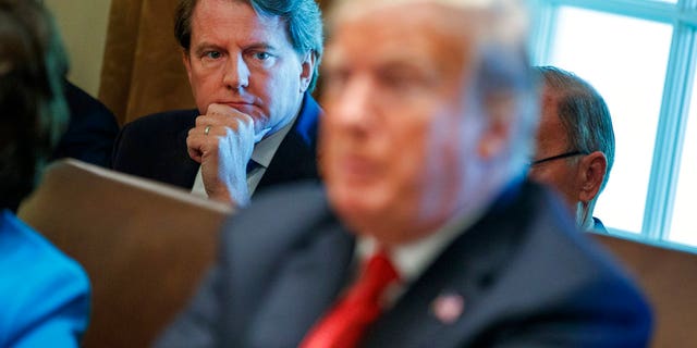 FILE: White House counsel Don McGahn looks on while President Donald Trump speaks during a cabinet meeting. Wednesday, Oct. 17, 2018, in Washington.