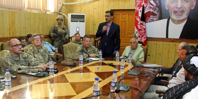 The head of NATO troops in Afghanistan, Gen. Scott Miller, center left, Kandahar Gov. Zalmay Wesa, center right, and their delegations attend a security conference, in Kandahar, Afghanistan, Thursday, Oct. 18, 2018.