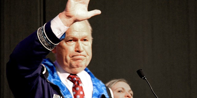 Alaska Gov. Bill Walker waves as he announces he will drop his re-election bid while addressing the Alaska Federation of Natives conference Friday, Oct. 19, 2018, in Anchorage. Walker's re-election plans were dealt a blow earlier in the week after his running mate, Lt. Gov. Byron Mallott, resigned after making an inappropriate overture toward a woman.