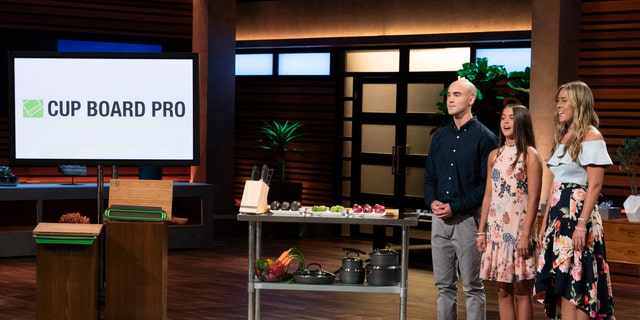 In this image provided by ABC, Kevin Young’s children present the product of their late father, Cup Board Pro, which is a chopping block that features a detachable bowl for clean up, on a "Shark Tank" episode that aired on Sunday, Oct. 21, 2018.