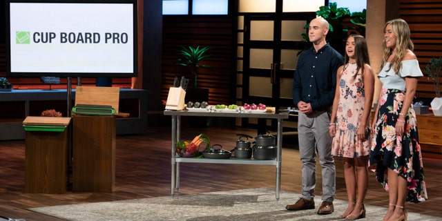 In this image provided by ABC, Kevin Young’s children present the product of their late father, Cup Board Pro, which is a chopping block that features a detachable bowl for clean up, on a "Shark Tank" episode that aired on Sunday, Oct. 21, 2018.