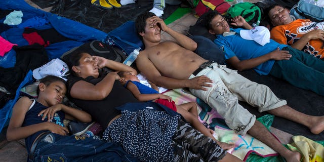 Honduran migrants rest in Pijijiapan, Mexico, Thursday, Oct. 25, 2018. Thousands of Central American migrants have renewed their hoped-for march to the United States on Wednesday. (AP Photo/Rodrigo Abd)