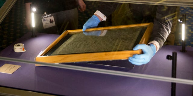 The Salisbury Cathedral 1215 copy of the Magna Carta is installed in a glass display cabinet marking the 800th anniversary of the sealing of Magna Carta at Runnymede in 1215, in Salisbury, England. (AP Photo/Matt Dunham, FILE)