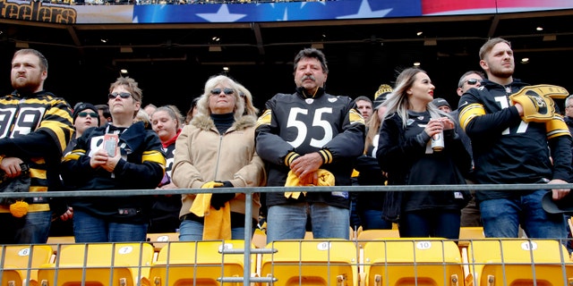 Pittsburgh Steelers fans stand for a moment of silence for the victims of a deadly shooting spree at a synagogue on Saturday before the start of an NFL football game against the Cleveland Browns, Sunday, Oct. 28, 2018, in Pittsburgh.