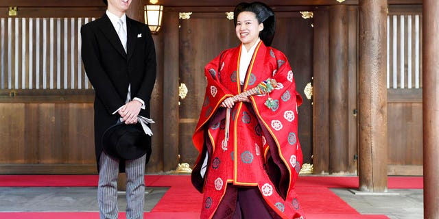 Japanese Princess Ayako, right, dressed in traditional ceremonial robe, and groom Kei Moriya, left, speak to the reporters after their wedding ceremony at Meiji Shrine in Tokyo, Monday, Oct. 29, 2018. Japan's Princess Ayako, the daughter of the emperor's cousin, has married Moriya, a commoner in a ritual-filled ceremony at Tokyo's Meiji Shrine.(Kyodo News via AP)