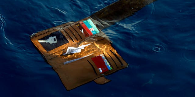 FILE: A wallet belonging to a victim of the Lion Air passenger jet that crashed is seen in the waters of Ujung Karawang, West Java, Indonesia.