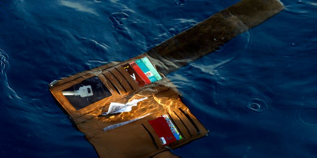 FILE: A wallet belonging to a victim of the Lion Air passenger jet that crashed is seen in the waters of Ujung Karawang, West Java, Indonesia.
