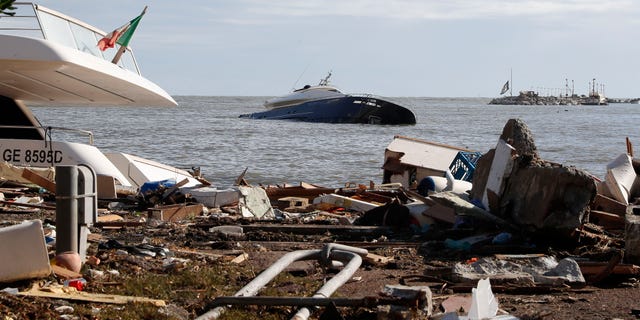 A partially sunken boat is seen at sea a day after a storm washed up several boats, in Rapallo, northern Italy, Tuesday, Oct. 30, 2018. (AP Photo/Antonio Calanni)