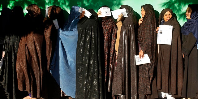 Women line up outside a polling station during the parliamentary election in western Herat city, Afghanistan, on Saturday. (AP Photo/Hamed Sarfarazi)
