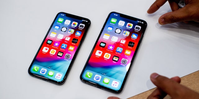 An Apple iPhone Xs Max (R) and iPhone Xs rest on a table during a launch event on September 12, 2018, in Cupertino, California. 