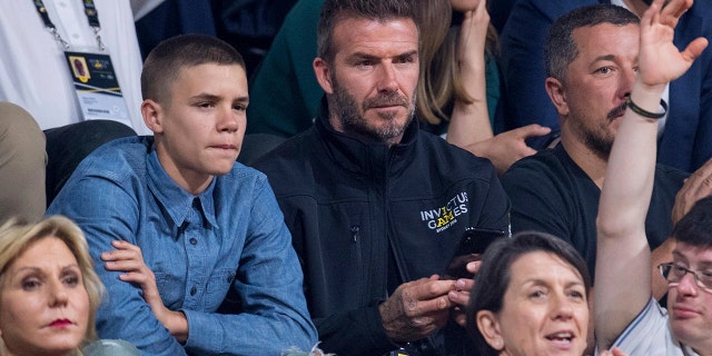 Former England footballer David Beckham and his son Romeo watch the wheelchair basketball final at The Invictus Games in Sydney, Australia, Saturday, Oct. 27, 2018. Prince Harry and his wife Meghan are on day twelve of their 16-day tour of Australia and the South Pacific. (AP Photo)