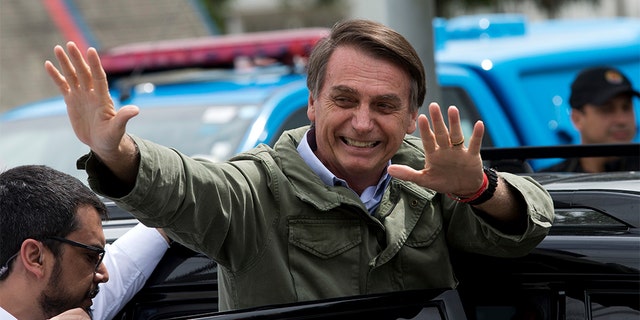 Jair Bolsonaro, presidential candidate with the Social Liberal Party, waves after voting in the presidential runoff election in Rio de Janeiro, Brazil, Sunday, Oct. 28, 2018. Bolsonaro is running against leftist candidate Fernando Haddad of the Workers’ Party. 
