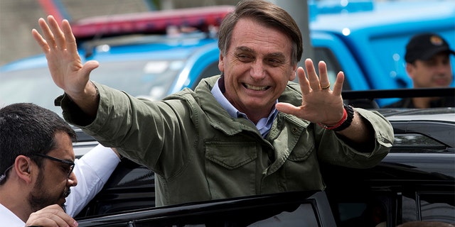 Jair Bolsonaro, presidential candidate with the Social Liberal Party, waves after voting in the presidential runoff election in Rio de Janeiro, Brazil, Sunday, Oct. 28, 2018. Bolsonaro is running against leftist candidate Fernando Haddad of the Workers’ Party. 