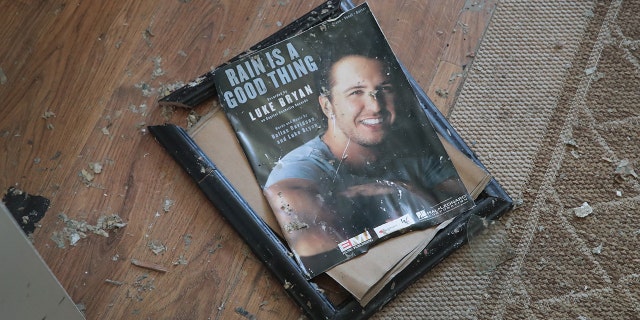 A framed photo of Luke Bryan reportedly damaged at his mom's house from Hurricane Michael.