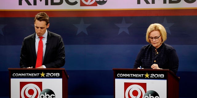 FILE - Missouri U.S. Senate candidates incumbent Democratic Sen. Claire McCaskill, right, and Republican challenger Josh Hawley look over their notes before the start of a debate.