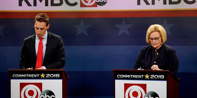 FILE - Missouri U.S. Senate candidates incumbent Democratic Sen. Claire McCaskill, right, and Republican challenger Josh Hawley look over their notes before the start of a debate.