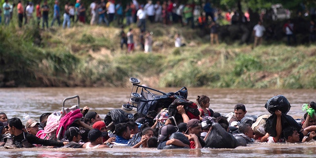 A group of Central American migrants wading across the Suchiate River. (AP Photo/Santiago Billy)