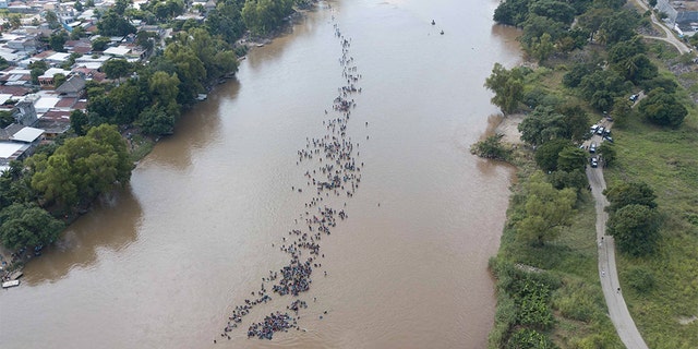 A new group of Central American migrants bound for the U.S border, wading across the Suchiate River, that connects Guatemala and Mexico, in Tecun Uman, Guatemala. (AP Photo/Santiago Billy)