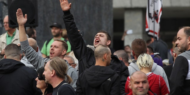 A man raises his arm in a Heil Hitler salute towards heckling leftists at a right-wing protest gathering the day after a man was stabbed and died of his injuries on August 27, 2018 in Chemnitz, Germany