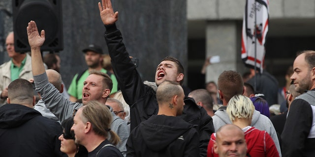 A man raises his arm in a Heil Hitler salute towards heckling leftists at a right-wing protest gathering the day after a man was stabbed and died of his injuries on August 27, 2018 in Chemnitz, Germany