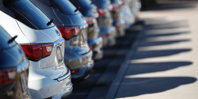 In this Oct. 21, 2018, photo a long line of unsold 2018 QX60 sports utility vehicles cast long shadows at an Infiniti dealership in Highlands Ranch, Colo. On Monday, Oct. 29, the Commerce Department issues its September report on consumer spending, which accounts for roughly 70 percent of U.S. economic activity. (AP Photo/David Zalubowski)