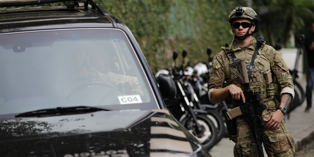 A federal police officer standing guard in Rio de Janeiro, in October 2018. The city is set to try "license to kill" policing next year, according to a report. (AP Photo/Leo Correa, File)