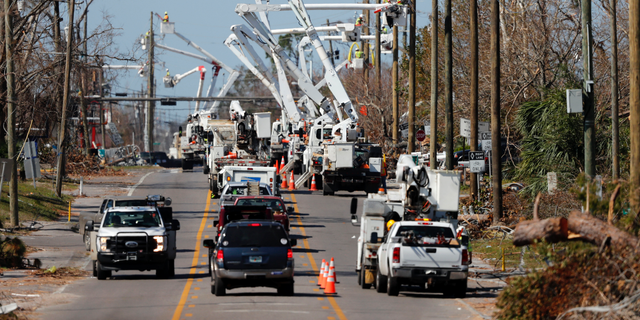 In this Thursday, Oct. 18, 2018 photo, utility crews set up new poles and utility wires in the aftermath of Hurricane Michael in Panama City, Fla. It's the greatest need after a hurricane and sometimes the hardest one to fulfill: Electricity. More than a week after Hurricane Michael smashed into the Florida Panhandle on a path of destruction that led all the way to the Georgia border, more than 100,000 Florida customers were still without power, according to the state Department of Emergency Management website. (AP Photo/Gerald Herbert)