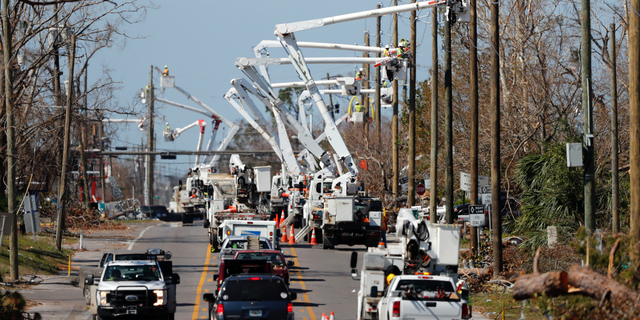 In this Thursday, Oct. 18, 2018 photo, utility crews set up new poles and utility wires in the aftermath of Hurricane Michael in Panama City, Fla. It's the greatest need after a hurricane and sometimes the hardest one to fulfill: Electricity. More than a week after Hurricane Michael smashed into the Florida Panhandle on a path of destruction that led all the way to the Georgia border, more than 100,000 Florida customers were still without power, according to the state Department of Emergency Management website. (AP Photo/Gerald Herbert)