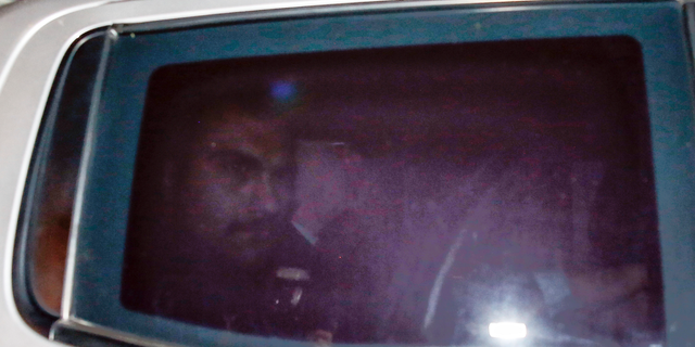 Pastor Andrew Brunson, center, sits inside a car as he arrives for his trial in Izmir, Turkey, early Friday.,