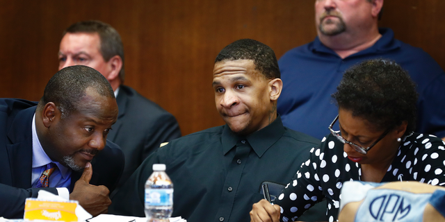 Defendant Quinton Tellis, center, looks on as the jury goes to deliberate his case in Batesville, Mississippi on Sept. 30, 2018.