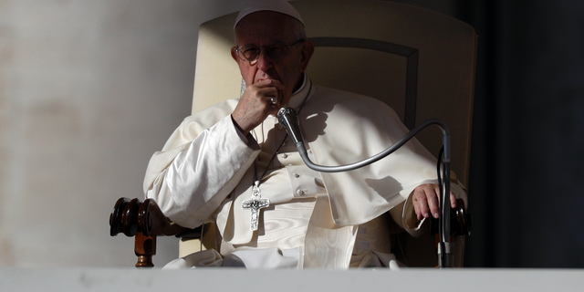 Pope Francis listens to the welcome speeches during his weekly general audience in St. Peter's Square at the Vatican, Wednesday, Oct. 24, 2018. (AP Photo/Gregorio Borgia)