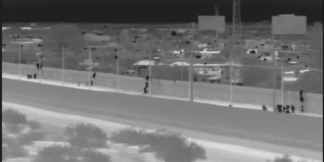 This image from video provided by the Yuma Sector Border Patrol shows a large group of Central American migrants being dropped over the U.S.-Mexico border wall east of the San Luis Port of Entry in Yuma, Arizona, on Friday, Oct. 19, 2018. (Yuma Sector Border Patrol via AP)