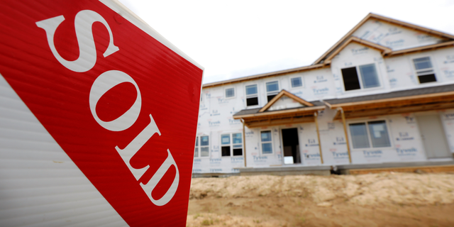 FILE- In this June 27, 2018, file photo, a sold sign stands in front of a home under construction in West Des Moines, Iowa. On Wednesday, Oct. 24, the Commerce Department reports on sales of new homes in September. (AP Photo/Charlie Neibergall, File)