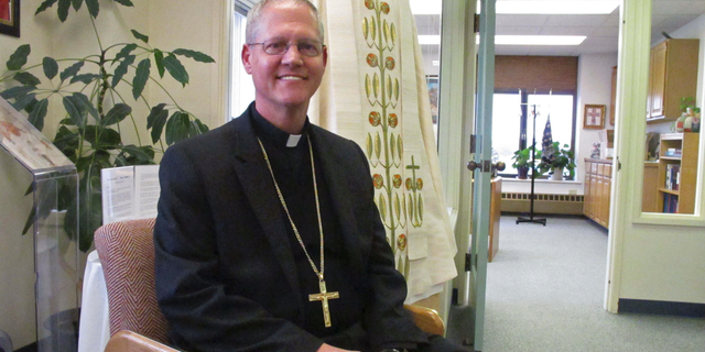 Catholic Archbishop Paul Etienne is shown Wednesday, Oct. 24, 2018, at his office in Anchorage, Alaska. Etienne said the Anchorage Archdiocese has ordered an independent review of sexual abuse claims by reviewing the files of priests and others associated with the archdiocese since it was established in 1966. (AP Photo/Rachel D'Oro)