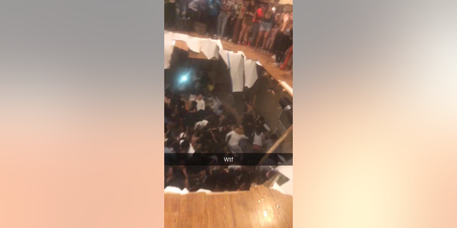 This frame from video shows a floor that collapsed during a party at an apartment near the campus of Clemson University early Sunday, Oct. 21, 2018, in Clemson, S.C. (Jeremy Tester via AP)