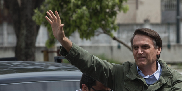 Presidential candidate Jair Bolsonaro, of the far-right Social Liberal Party waves to supporters after voting at a polling station in Rio de Janeiro, Brazil, Sunday, Oct. 28, 2018. Bolsonaro is running against leftist candidate Fernando Haddad of the Workers' Party. (AP Photo/Leo Correa)